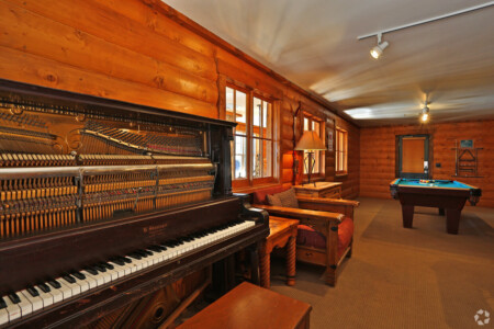 Upright piano in the lounge area at Blue Sky Lofts Apartments